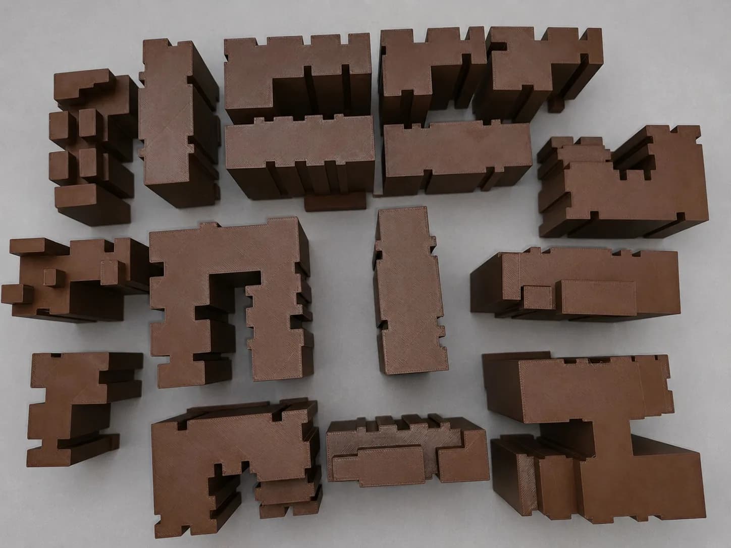 Top view of the separate 3D printed mass model pieces laid out apart, showing L- and U-shaped footprints