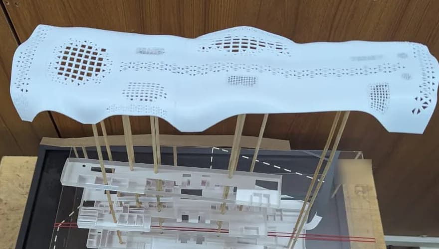 Detail of the 3D printed wavy roof with grid and triangle perforations above the acrylic floor plates