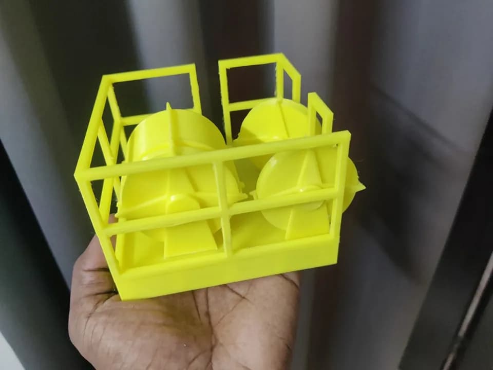 Front view of the printed crown block model showing the thin railing frame and two flanged drums