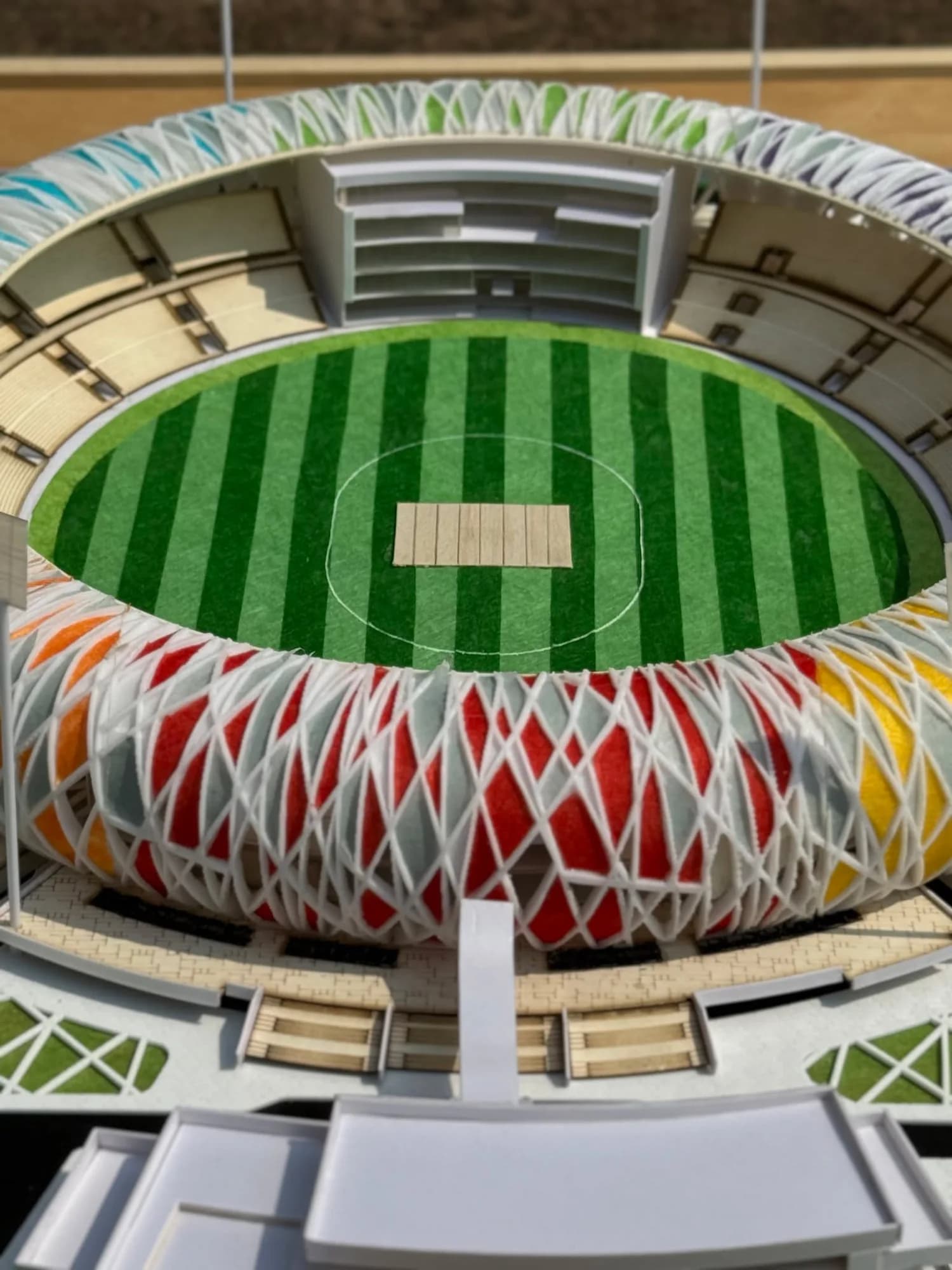 Close-up of the stands and field of the stadium model above the red and orange lattice panels