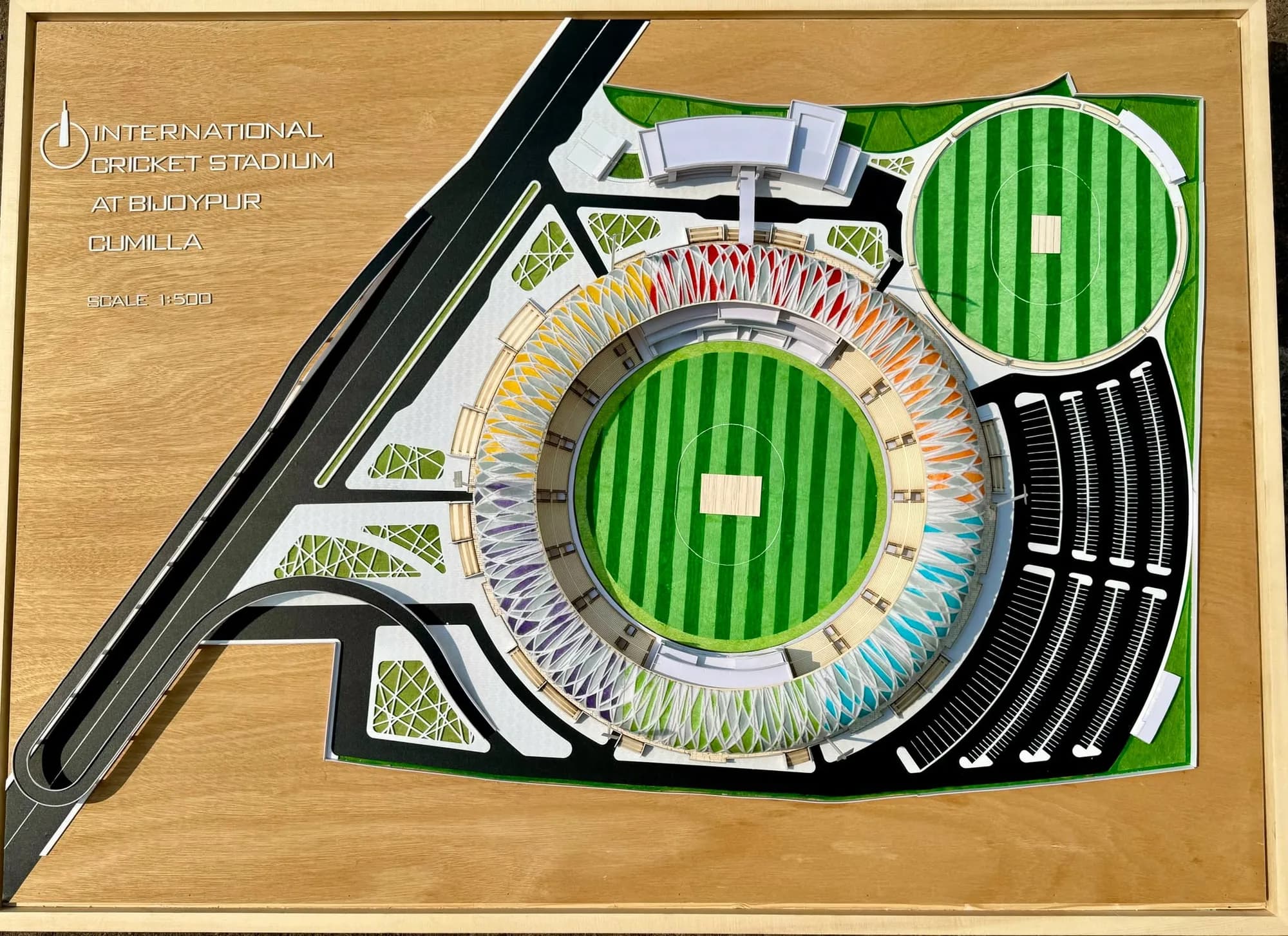 Top view of the International Cricket Stadium at Bijoypur, Cumilla model on a wooden base marked Scale 1:500