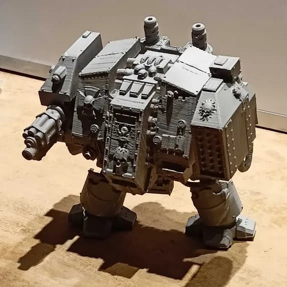 Angled view of the grey Dreadnought figure showing exhaust stacks and riveted shoulder armour