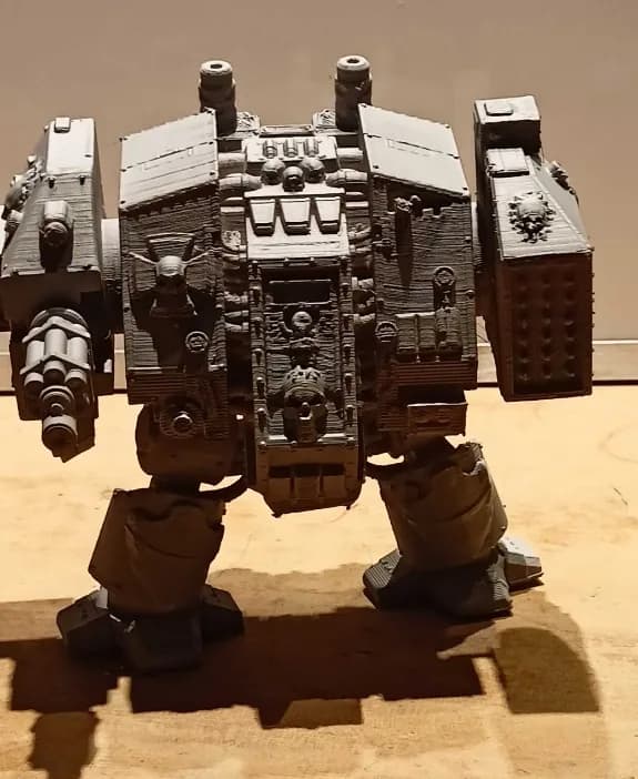 Dreadnought figure lit from the side, casting a long shadow, front armour detail in relief