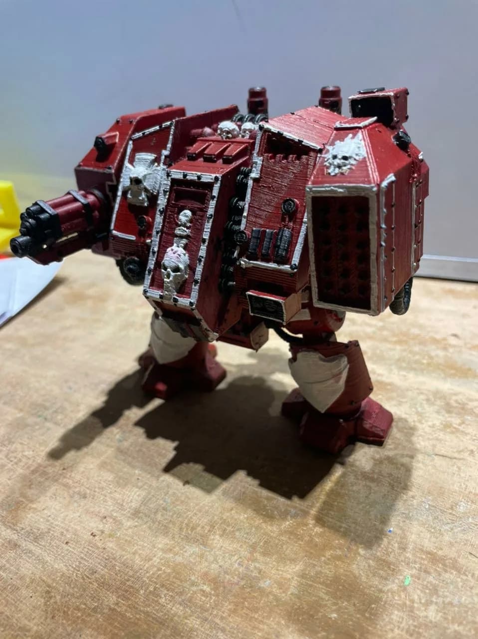 Painted red Dreadnought figure from the front left, black rotary weapon barrels and silver trim