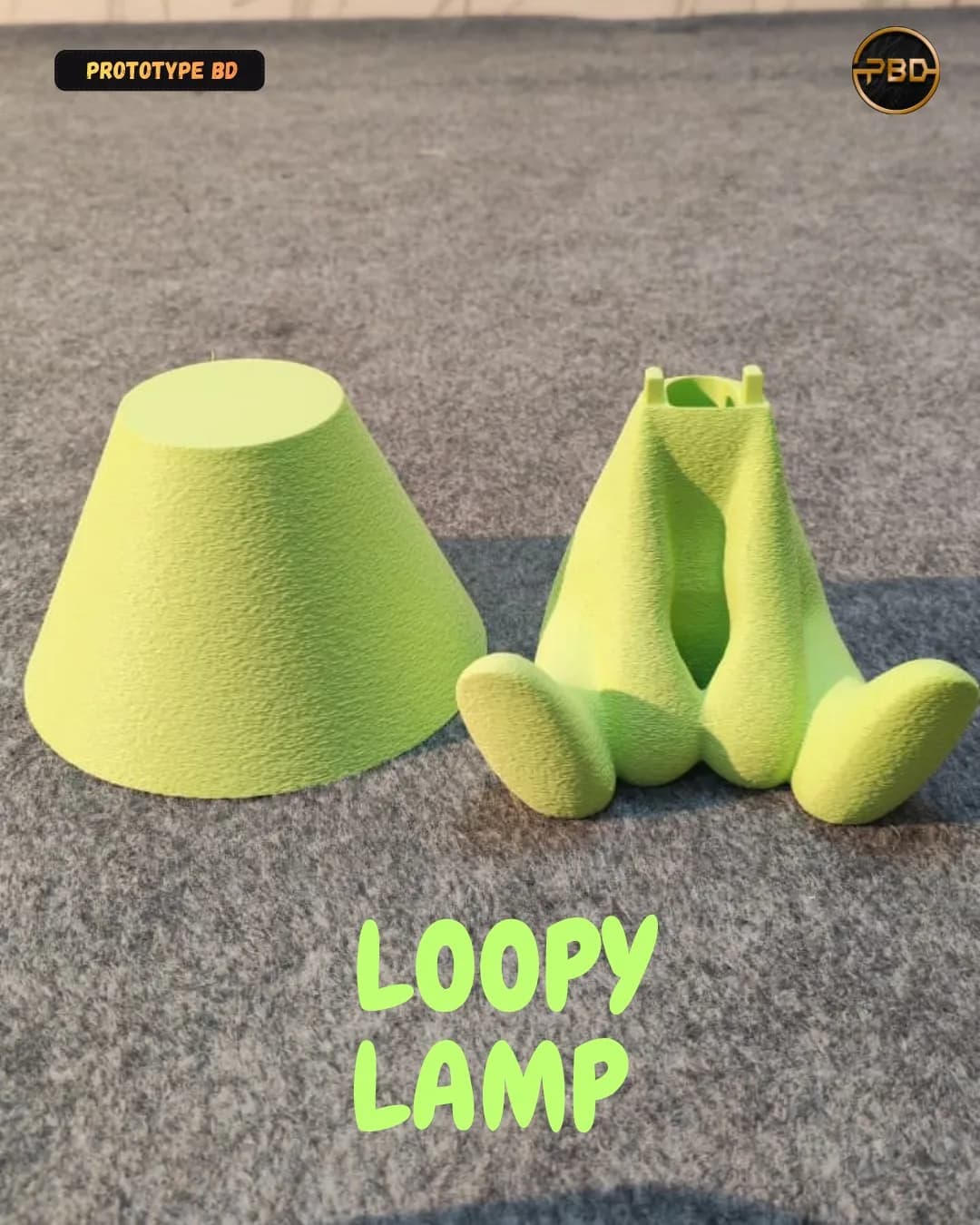 The two printed parts of the green Loopy Lamp side by side: the conical shade and the seated body with its hollow neck