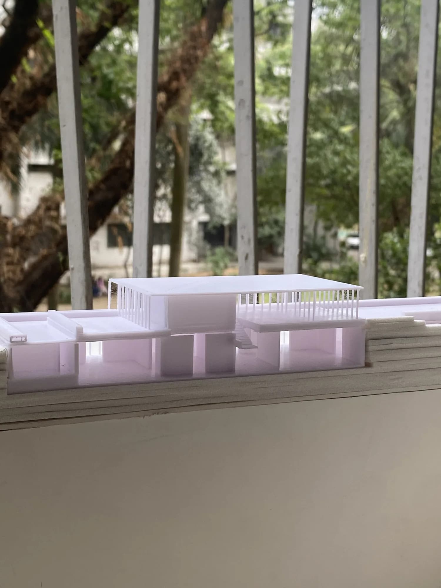 Eye-level view of the museum model's colonnade above the stacked terrain layers at the section cut