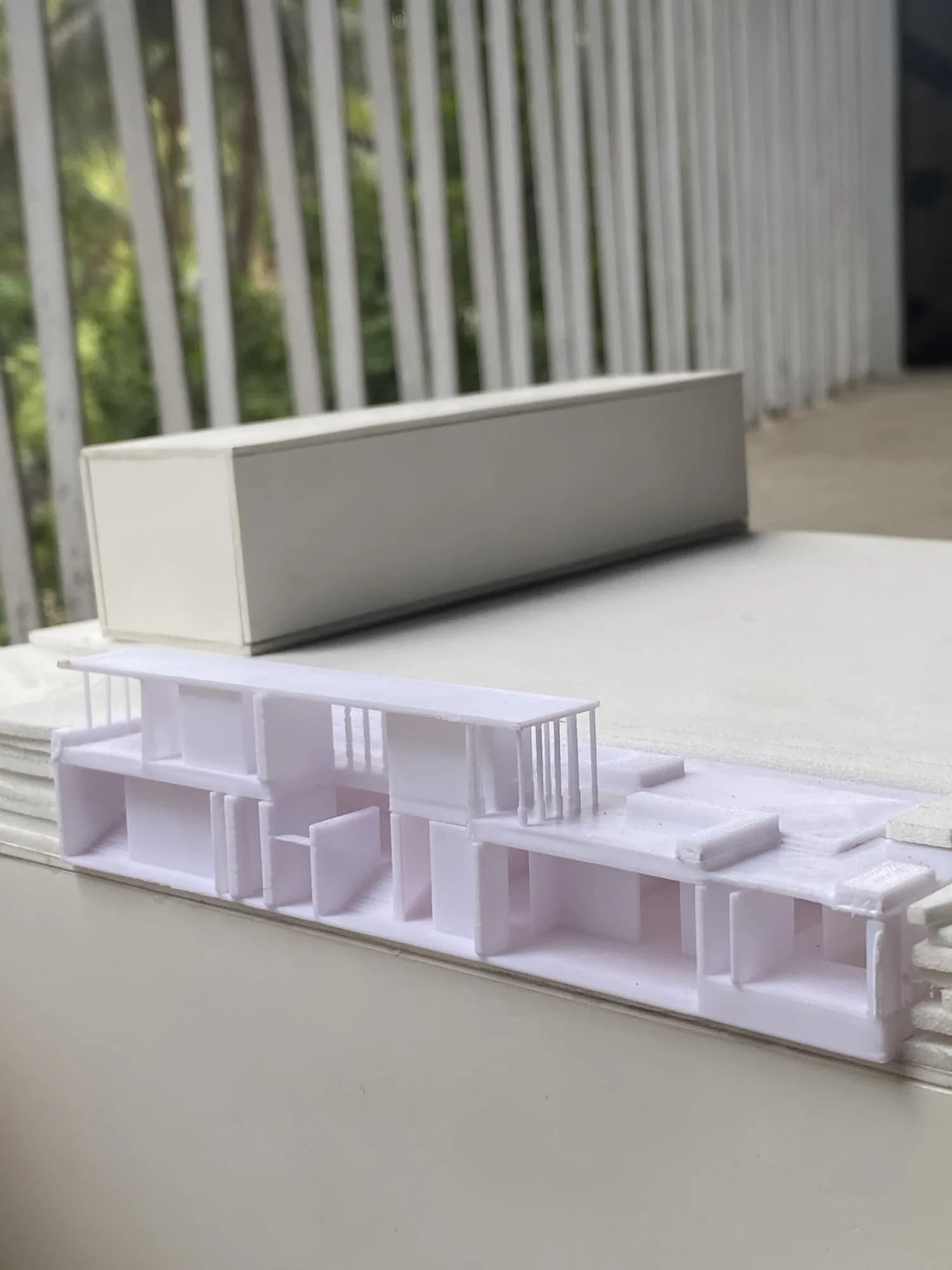 Section through the 3D printed museum model showing rooms and floor levels, with the neighbouring block behind