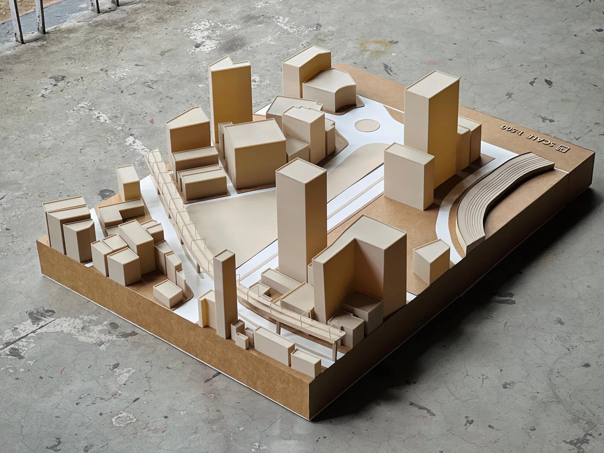 Overview of the Motijheel site model showing towers, the curving footbridge and the central open space