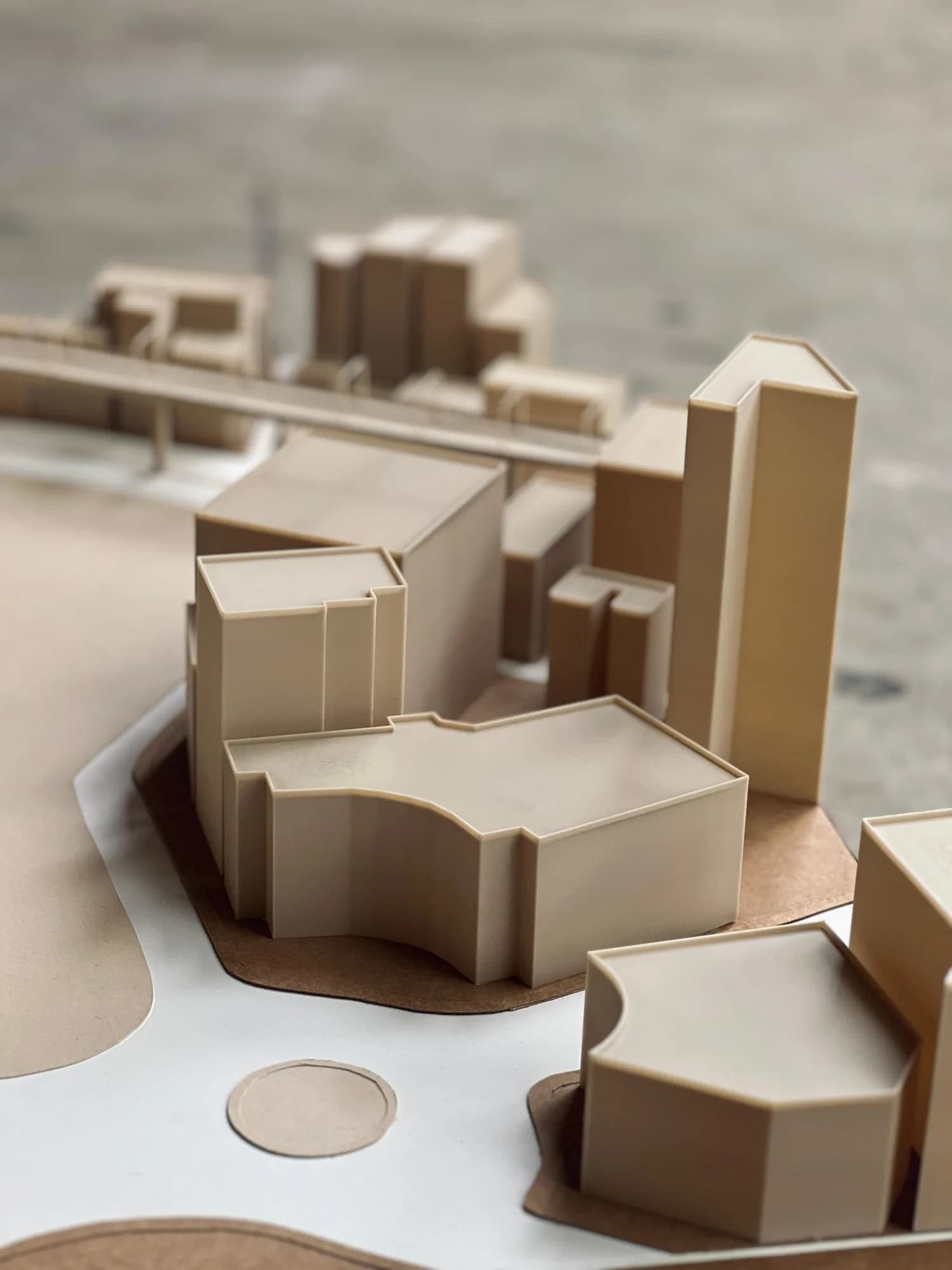 Close-up of 3D printed building blocks with curved and angled footprints on the Motijheel site model