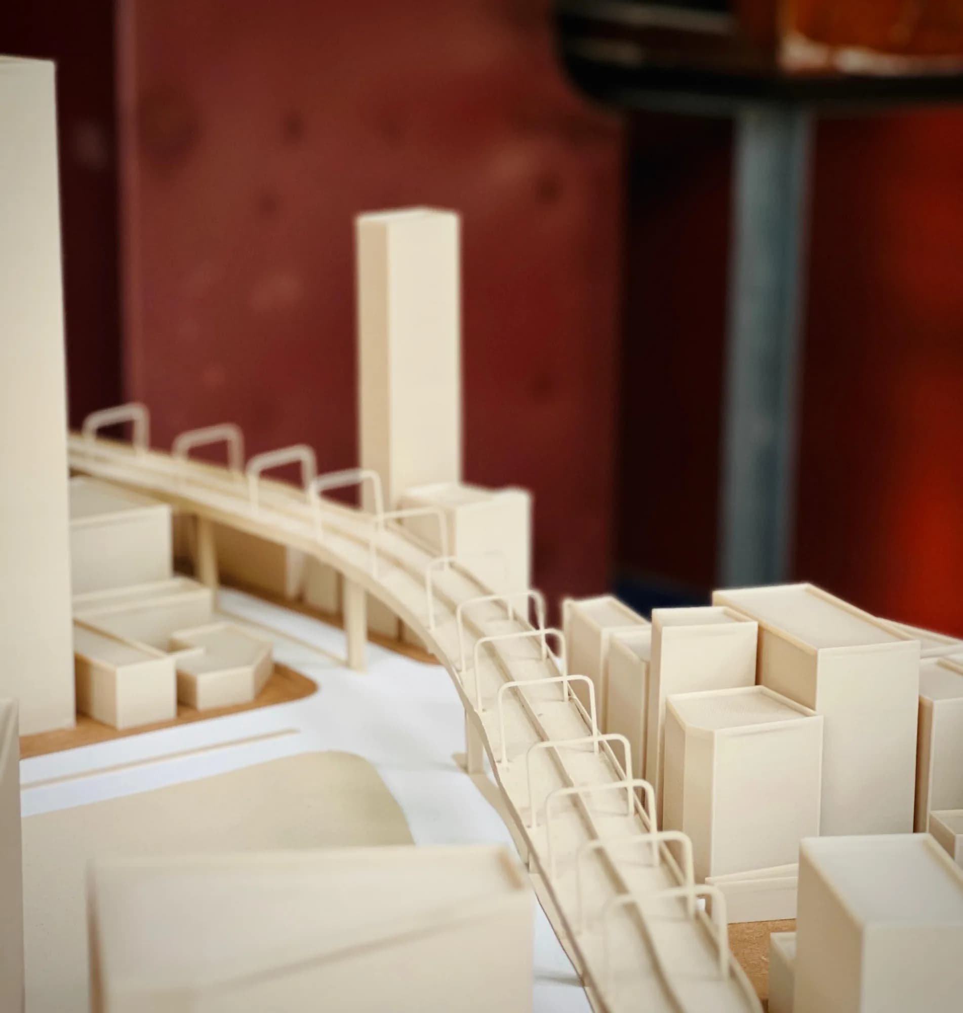 Close-up of the printed footbridge with arched railings curving between building blocks