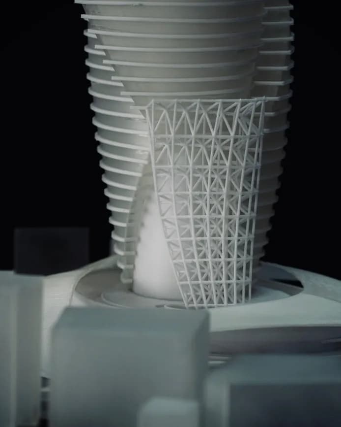 Detail of the fine 3D printed triangulated lattice beside the base of the tower model