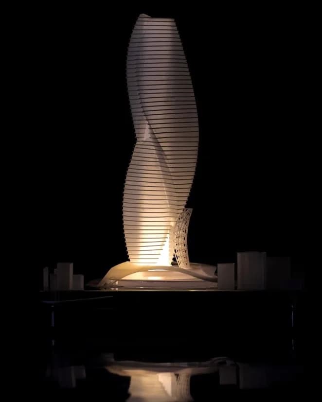 The Myofascial Rise model lit from inside, warm light glowing through the floor plates in a dark room