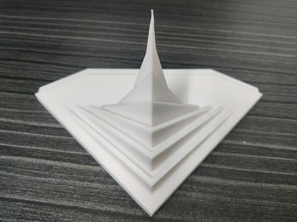Top-down view of the National Memorial miniature, nested triangular tiers on a faceted base