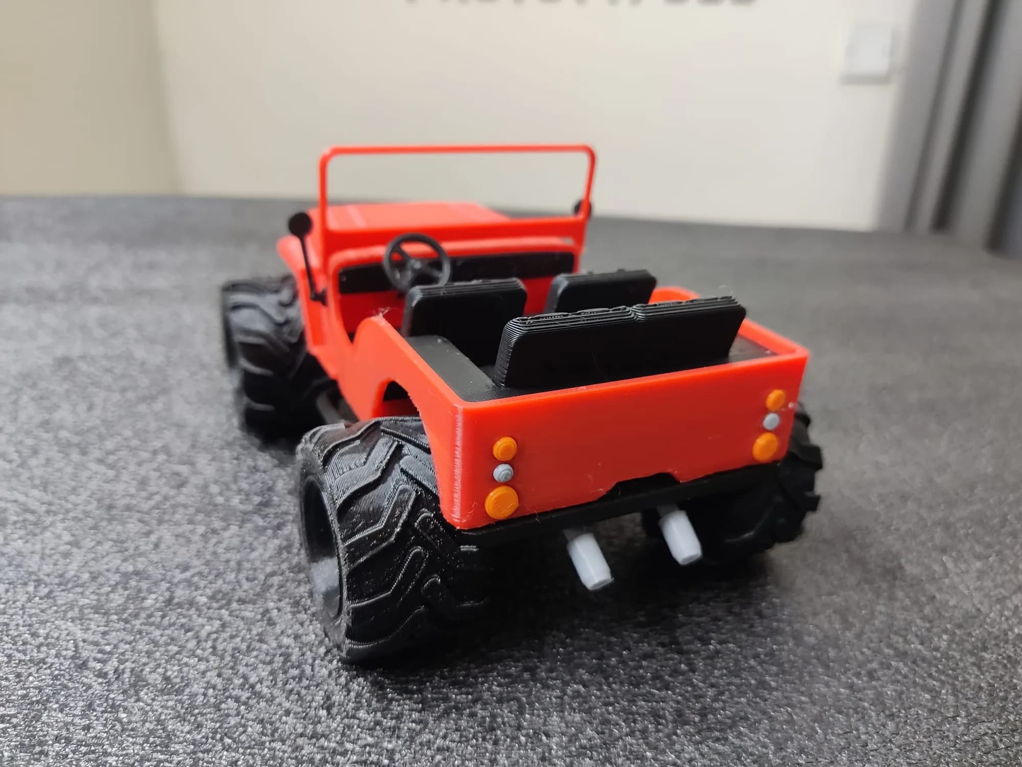 Rear of the printed jeep with orange tail lamps, grey exhaust tips and the rear seat