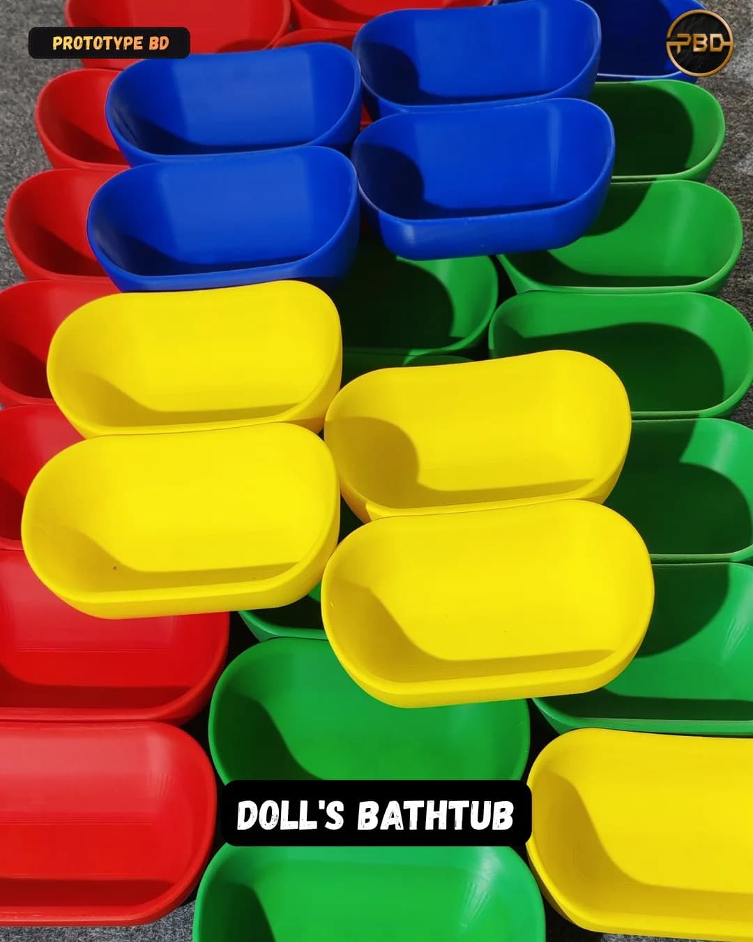 Dozens of 3D printed doll's bathtubs in red, blue, green and yellow laid out in rows