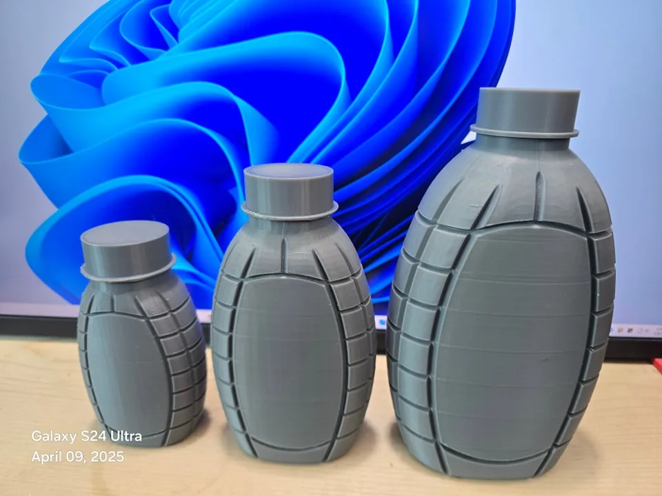 Three grey 3D printed bottle prototypes of the same ribbed design in small, medium and large sizes
