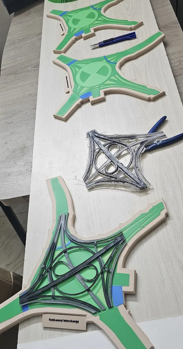 Work table with green printed interchange base pieces and a grey road network printed as a separate part