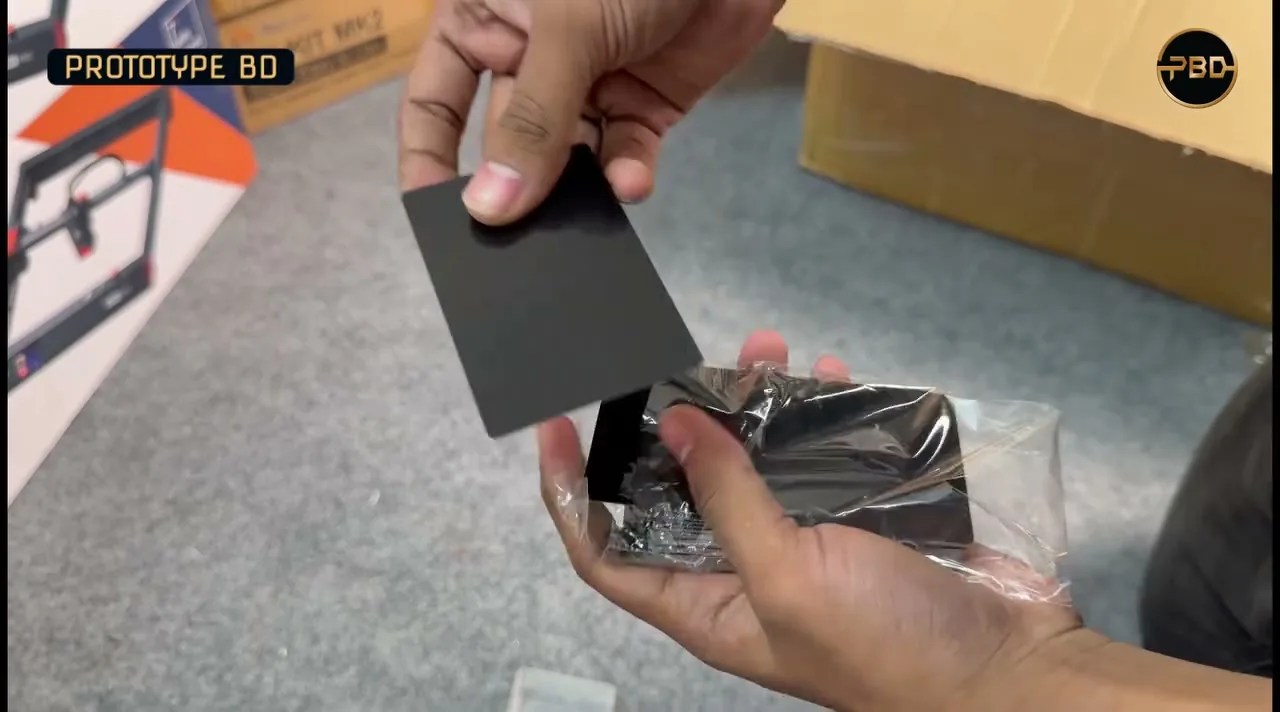 Hands holding black metal business card blanks taken out of a clear plastic case