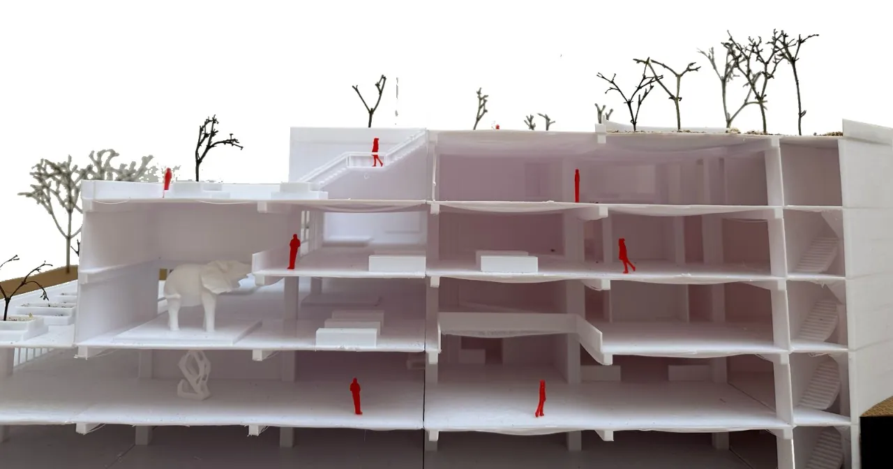 White 3D-printed sectional museum model cut open to show four floors, stairs and small red human figures
